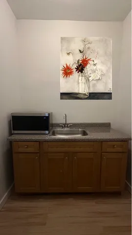 a view of kitchen island sink and wooden floor