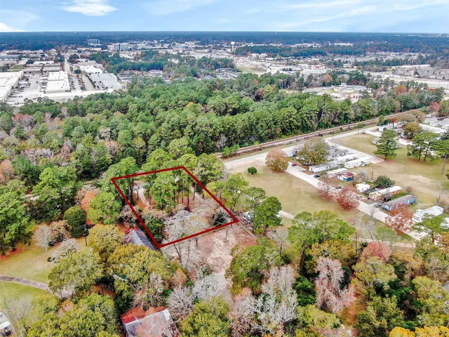an aerial view of a house with a yard