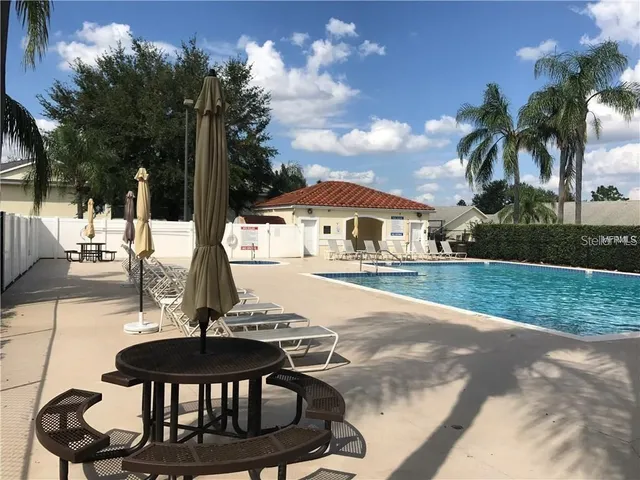 a swimming pool with some trees in the background