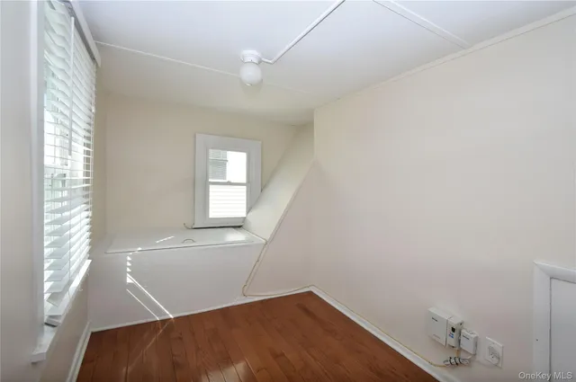 a view of a room with wooden floor and windows