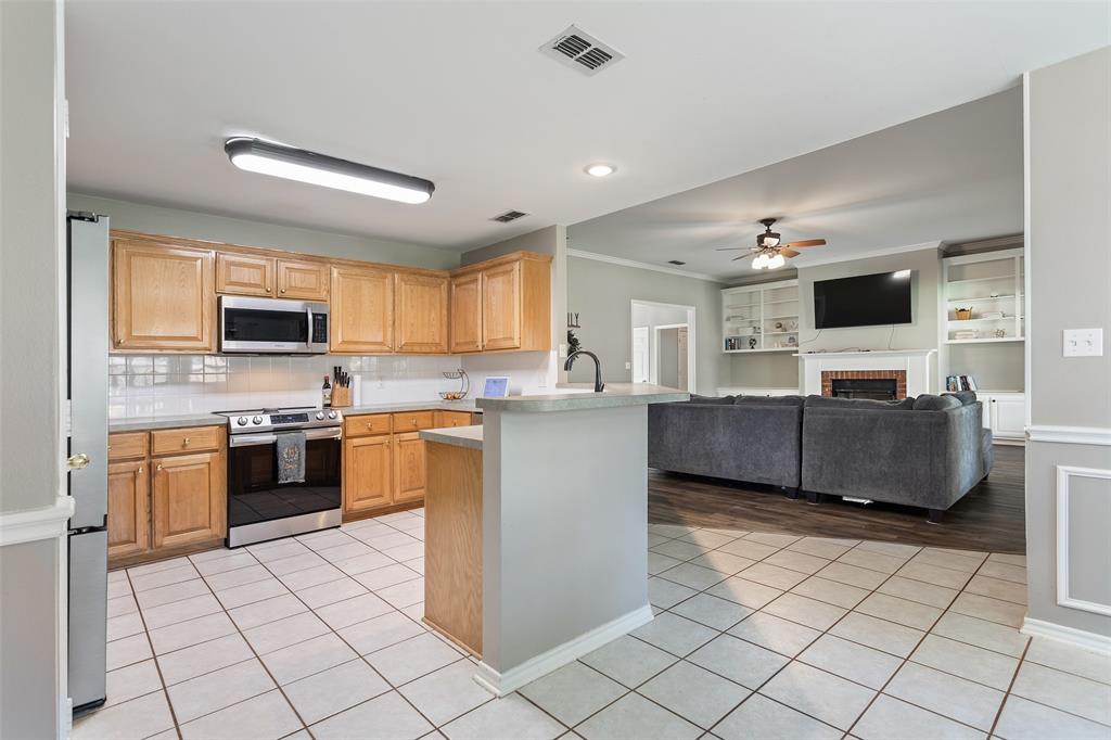 706 Maji Road Whitehouse, TX 75791 - Photo 12 of 37 a large kitchen with stainless steel appliances and cabinets