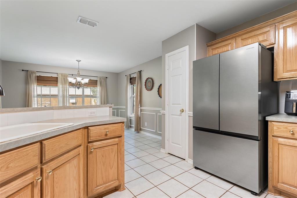 706 Maji Road Whitehouse, TX 75791 - Photo 15 of 37 a kitchen with granite countertop a refrigerator and a sink