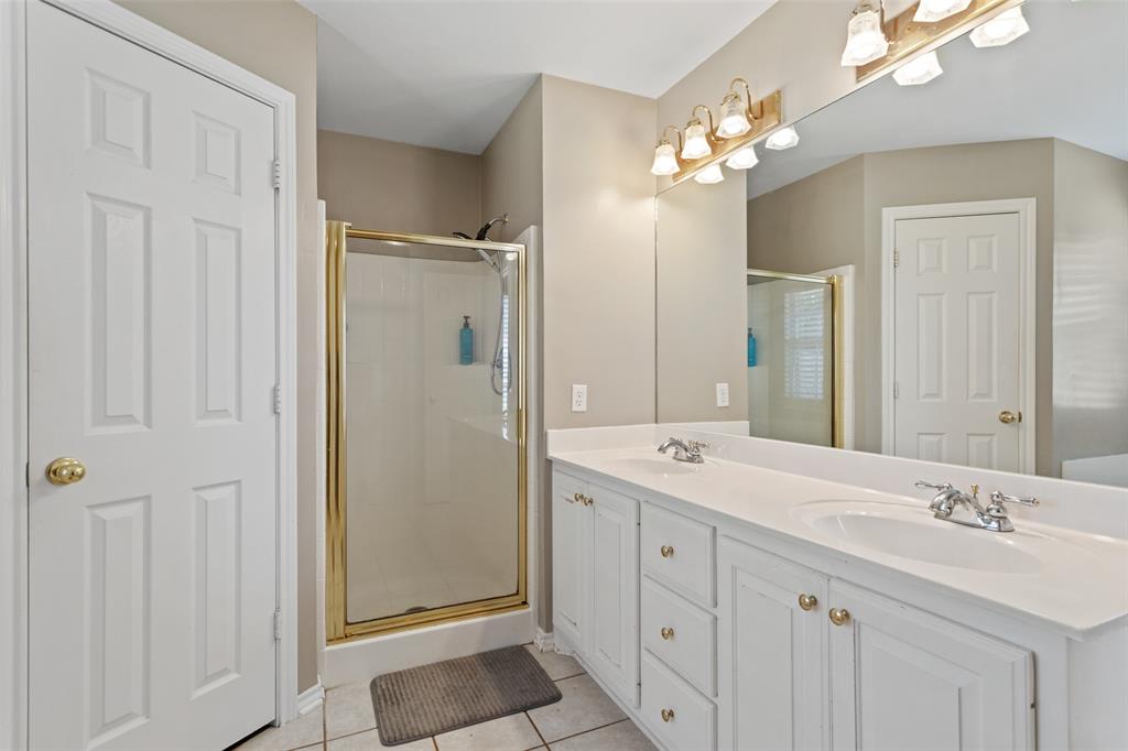 706 Maji Road Whitehouse, TX 75791 - Photo 19 of 37 a spacious bathroom with a double vanity sink mirror and shower