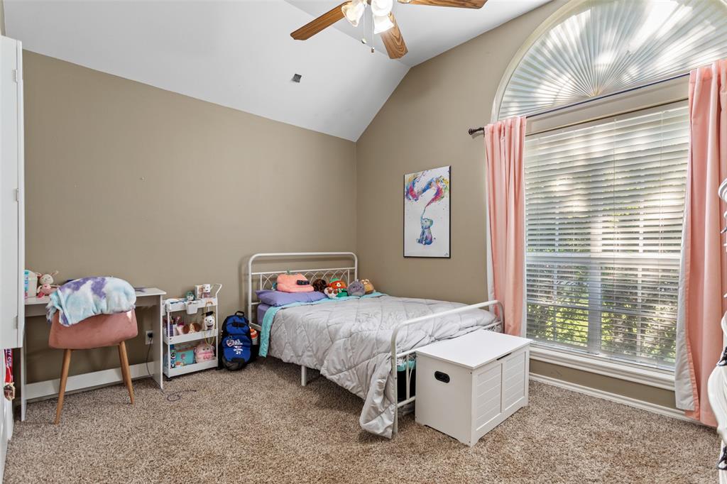 706 Maji Road Whitehouse, TX 75791 - Photo 22 of 37 a bedroom with a bed and a chandelier