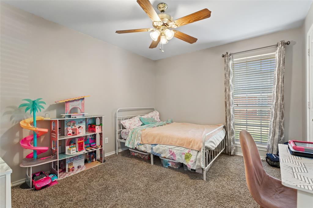 706 Maji Road Whitehouse, TX 75791 - Photo 23 of 37 a bedroom with bed and a chandelier
