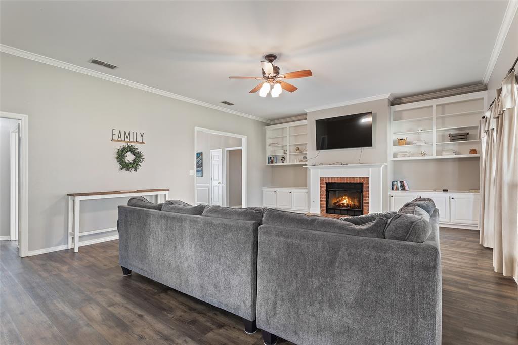 706 Maji Road Whitehouse, TX 75791 - Photo 10 of 37 a living room with furniture a flat screen tv and a fireplace