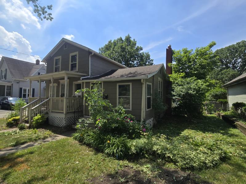219 South 7th Street DeKalb, IL 60115 - Photo 29 of 30 a view of a house with brick walls and a yard with plants
