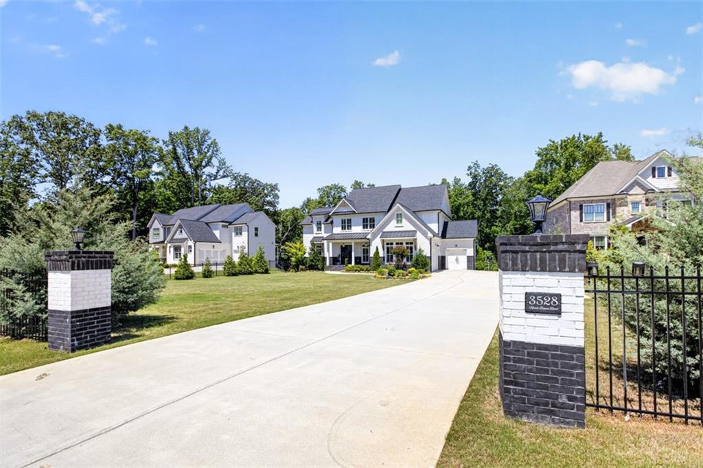 3528 North Bogan Road Buford, GA 30519 - Photo 2 of 79 a front view of a house with a yard and garage