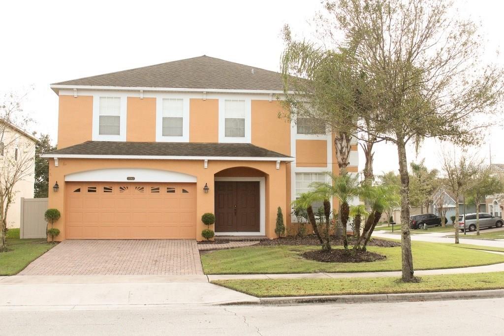 13063 Moss Park Ridge Drive Orlando, FL 32832 - Photo 1 of 1 a front view of a house with a yard and garage