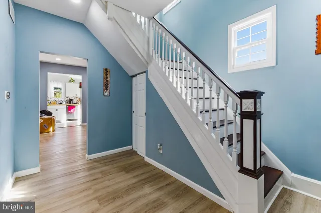 a view of entryway and hall with wooden floor