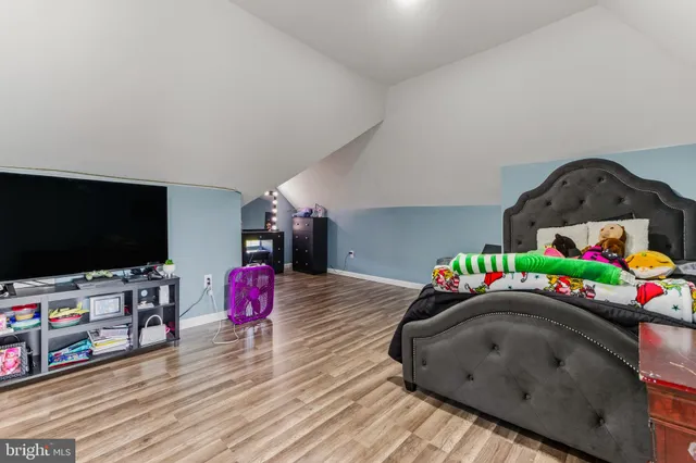 a bedroom with furniture and a flat screen tv