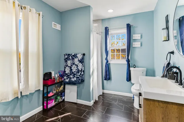 a view of entryway with furniture and wooden floor