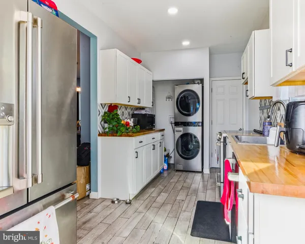 a kitchen with stainless steel appliances granite countertop a refrigerator and a stove