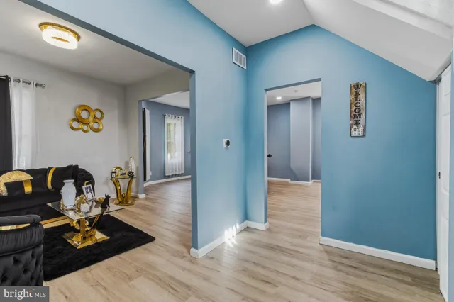 a view of a workspace room with wooden floor