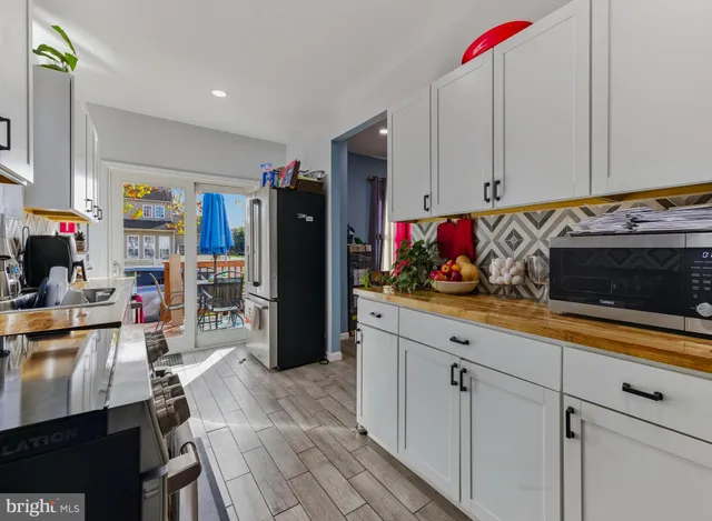 a kitchen with refrigerator and cabinets