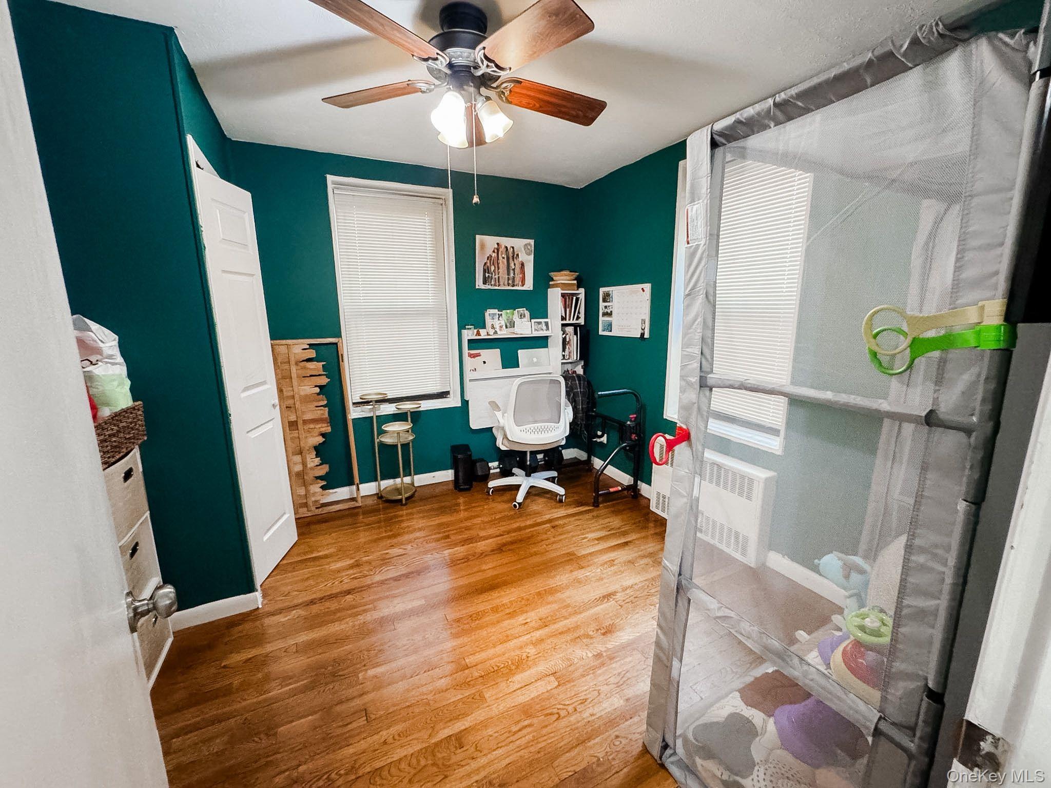 83-25 98th Street, Unit 1P Queens, NY 11421 - Photo 16 of 16 a bed room with a bed and a mirror