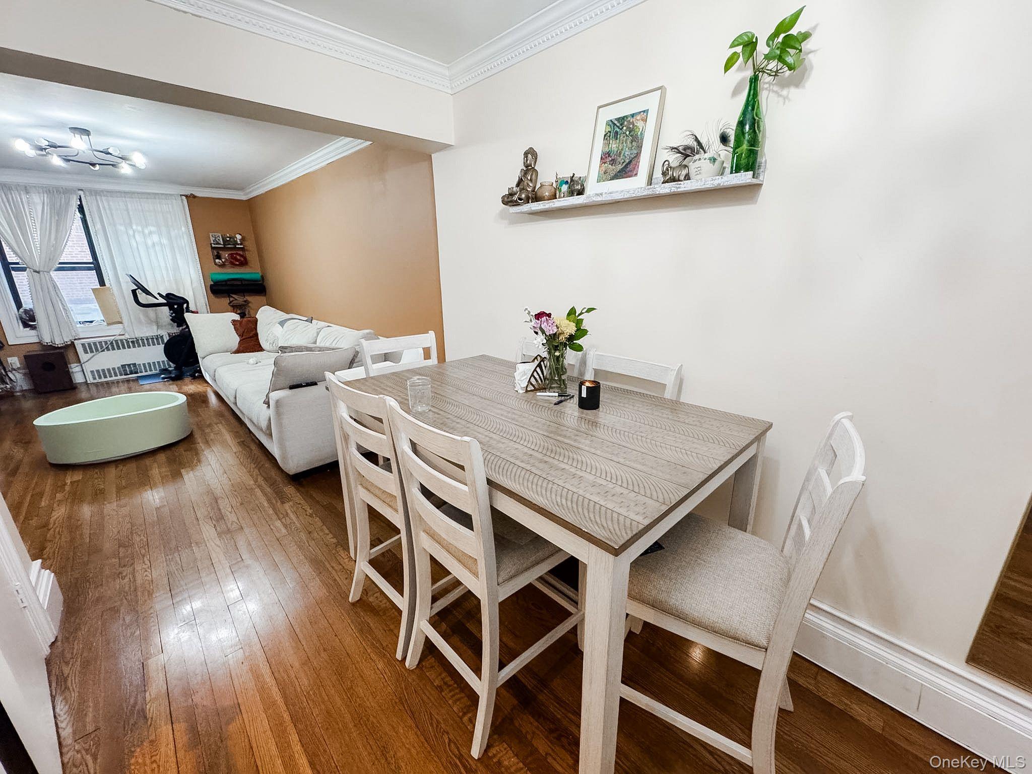83-25 98th Street, Unit 1P Queens, NY 11421 - Photo 7 of 16 a view of a dining room with furniture and wooden floor