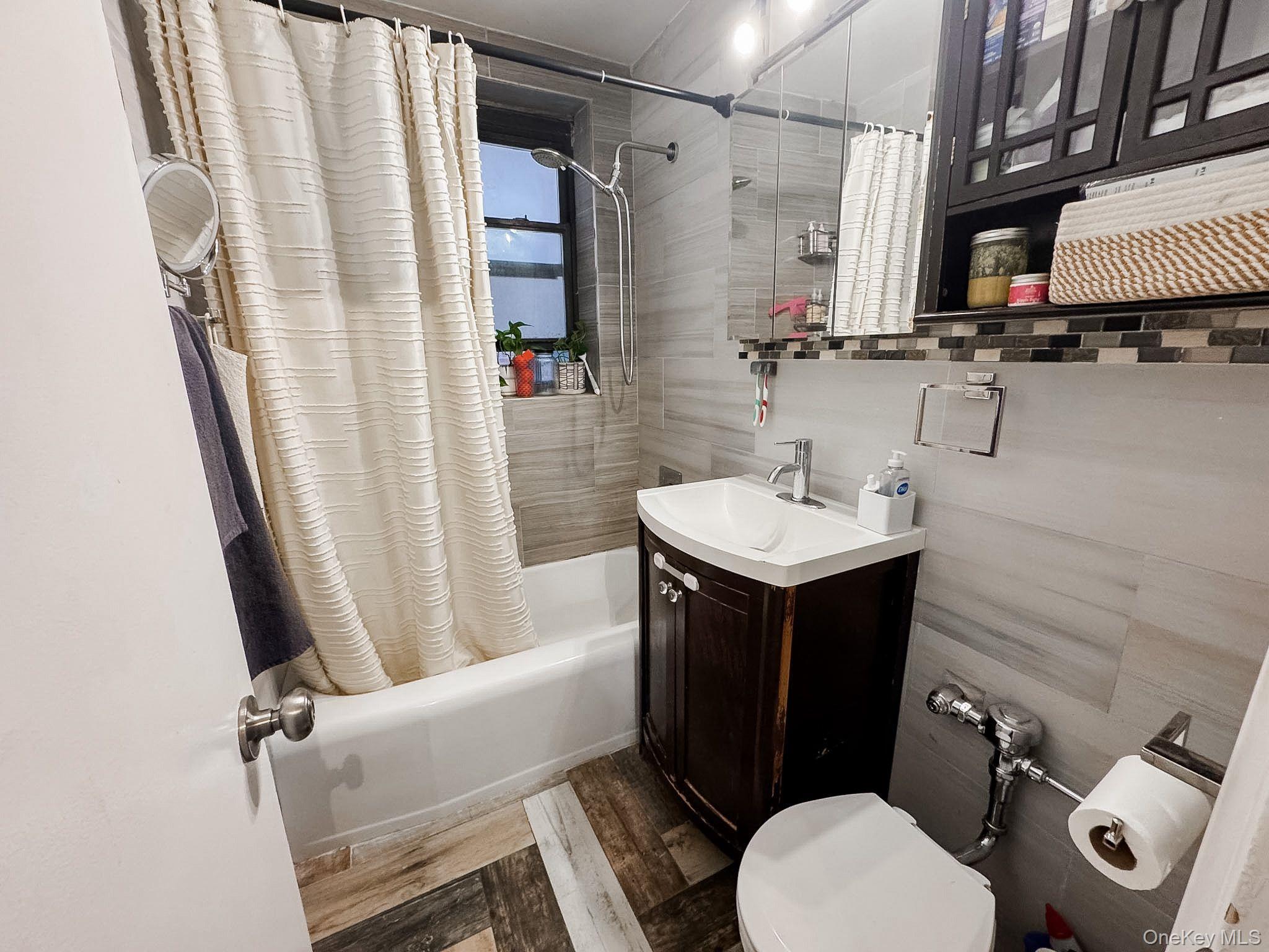 83-25 98th Street, Unit 1P Queens, NY 11421 - Photo 10 of 16 a bathroom with a sink toilet and shower