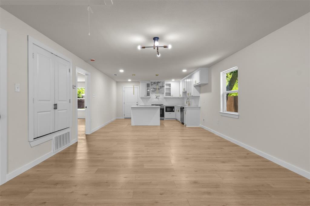 907 Pinson Road Forney, TX 75126 - Photo 8 of 35 Open concept living space featuring wood-finish flooring, recessed lighting, and a modern ceiling fixture