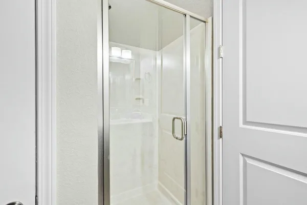 a view of a hallway with wooden floor and closet