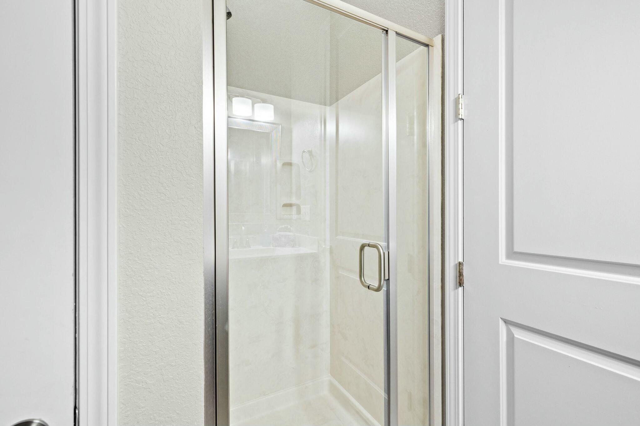 4596 Paradise Isle Destin, FL 32541 - Photo 11 of 60 a bathroom with a glass shower door