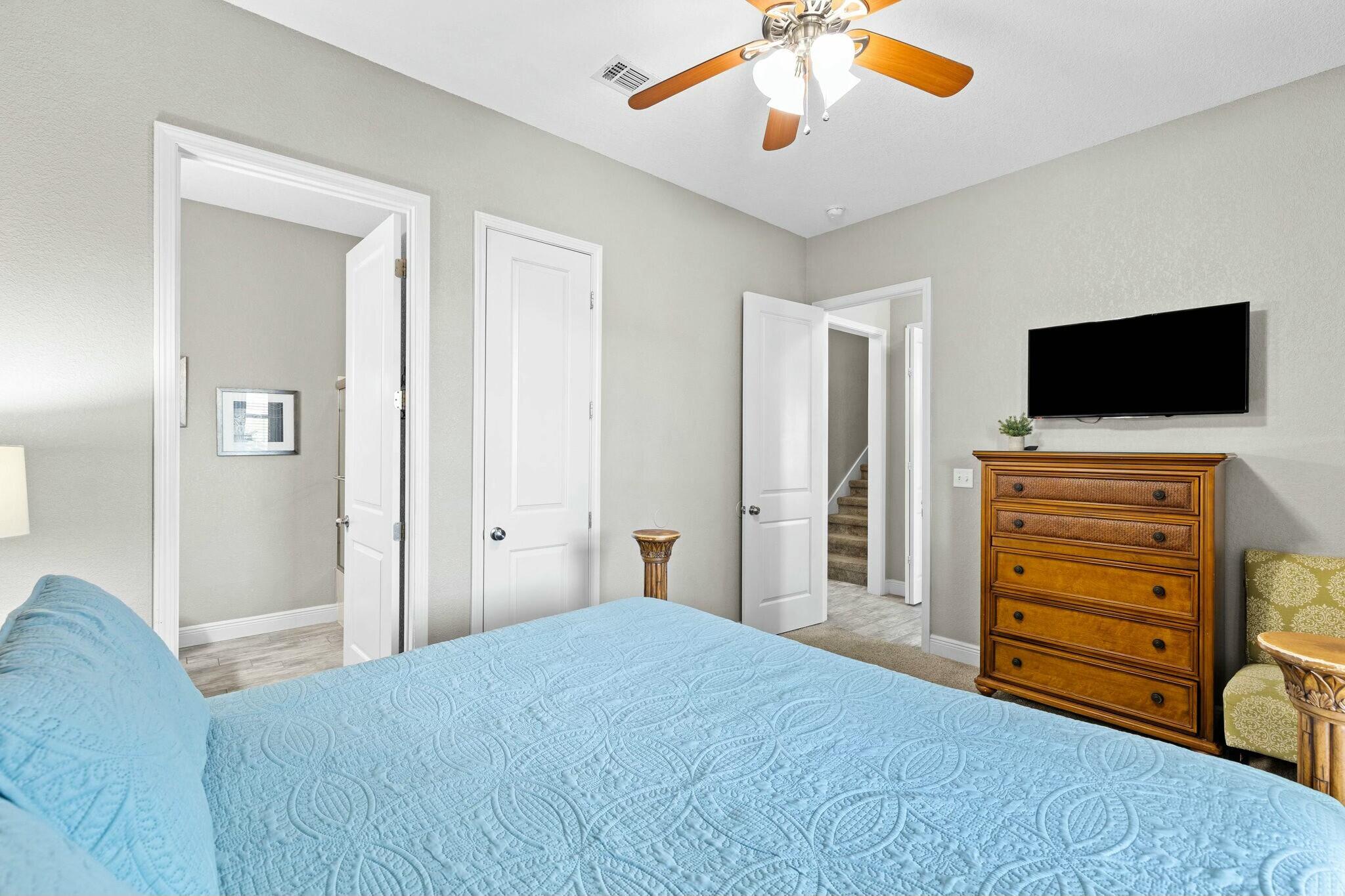 4596 Paradise Isle Destin, FL 32541 - Photo 15 of 60 a bedroom with a bed and a flat screen tv