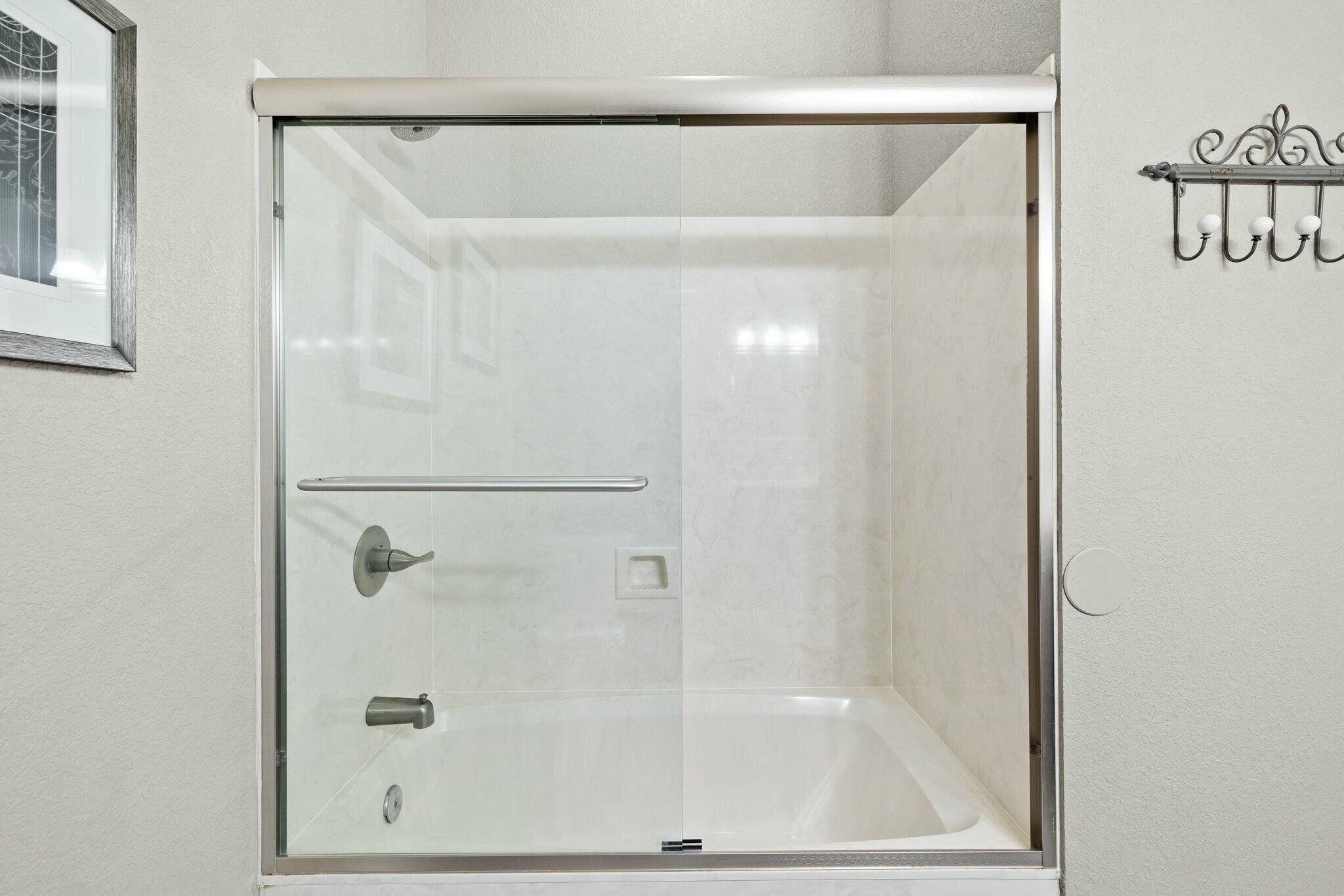 4596 Paradise Isle Destin, FL 32541 - Photo 17 of 60 a bathroom with a glass shower door