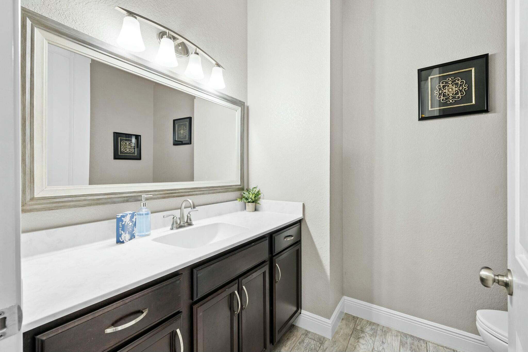 4596 Paradise Isle Destin, FL 32541 - Photo 18 of 60 a bathroom with a sink and a mirror