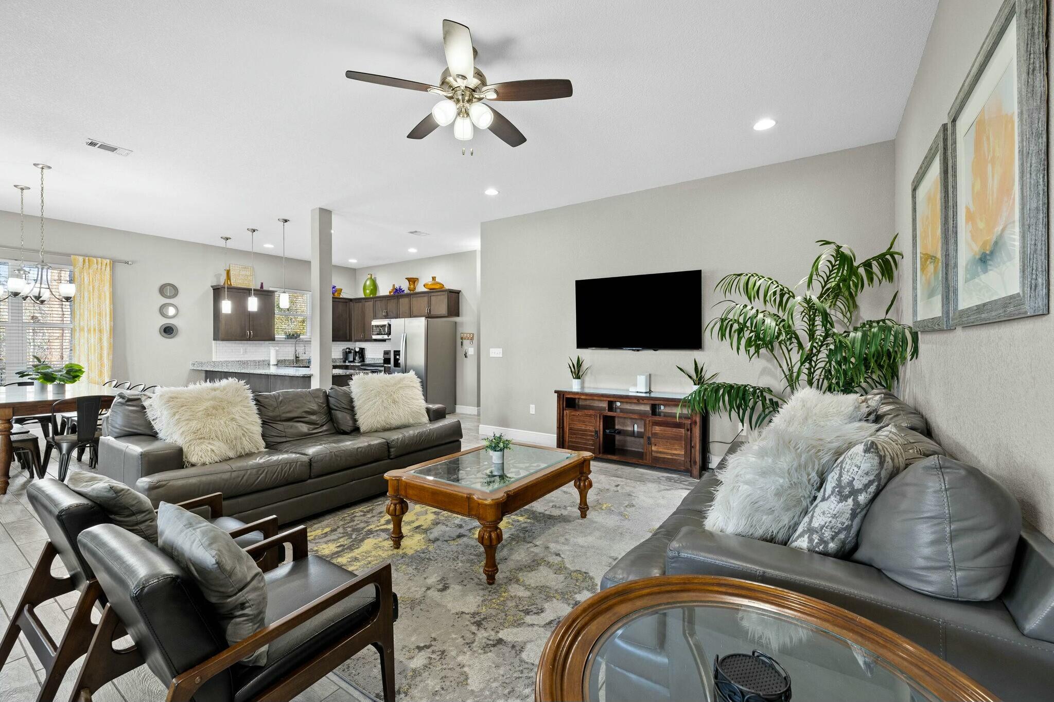 4596 Paradise Isle Destin, FL 32541 - Photo 21 of 60 a living room with furniture a ceiling fan and a flat screen tv