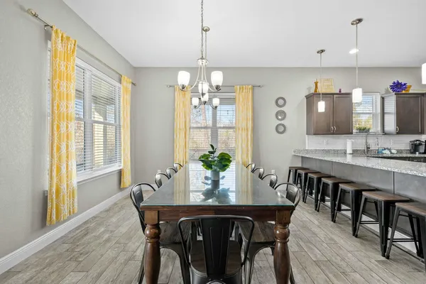 a large kitchen with a table and chairs