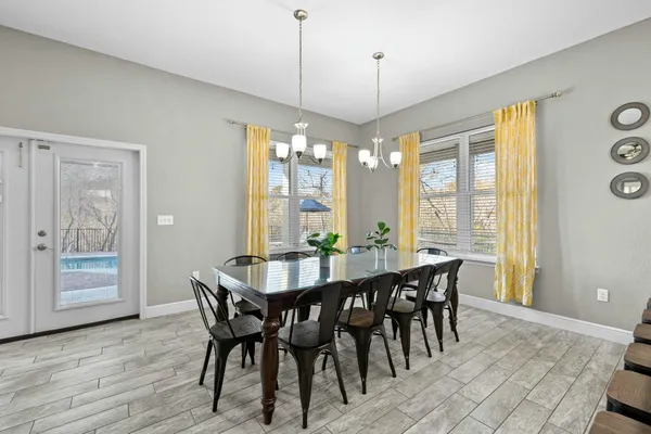 a large kitchen with a table and chairs in it