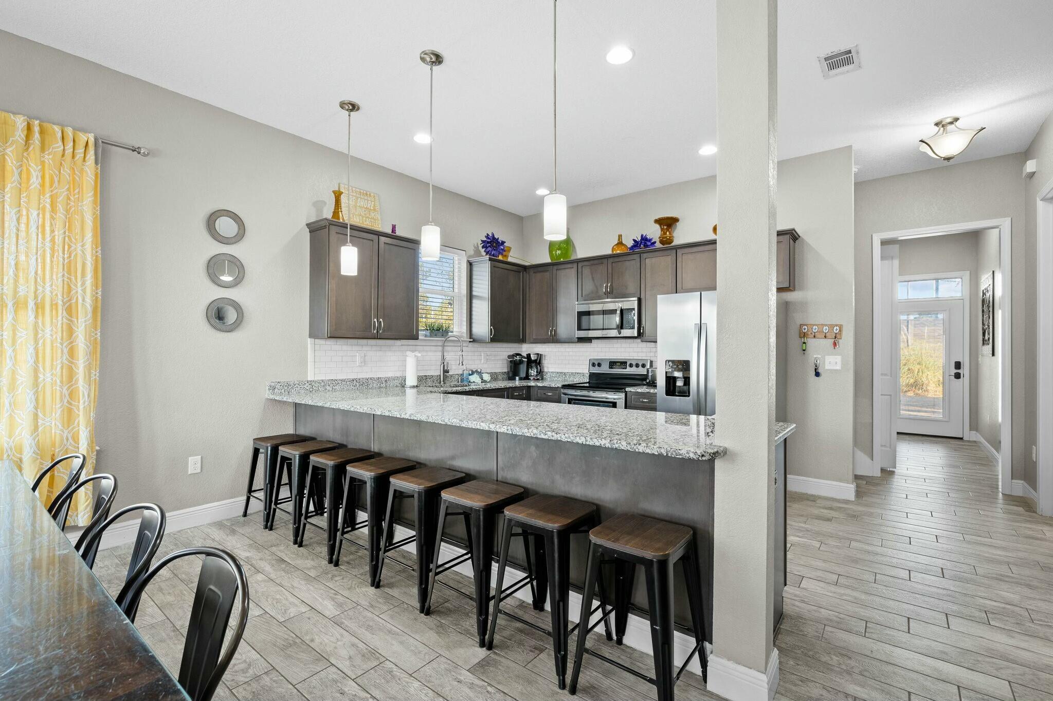 4596 Paradise Isle Destin, FL 32541 - Photo 26 of 60 a large kitchen with a table and chairs
