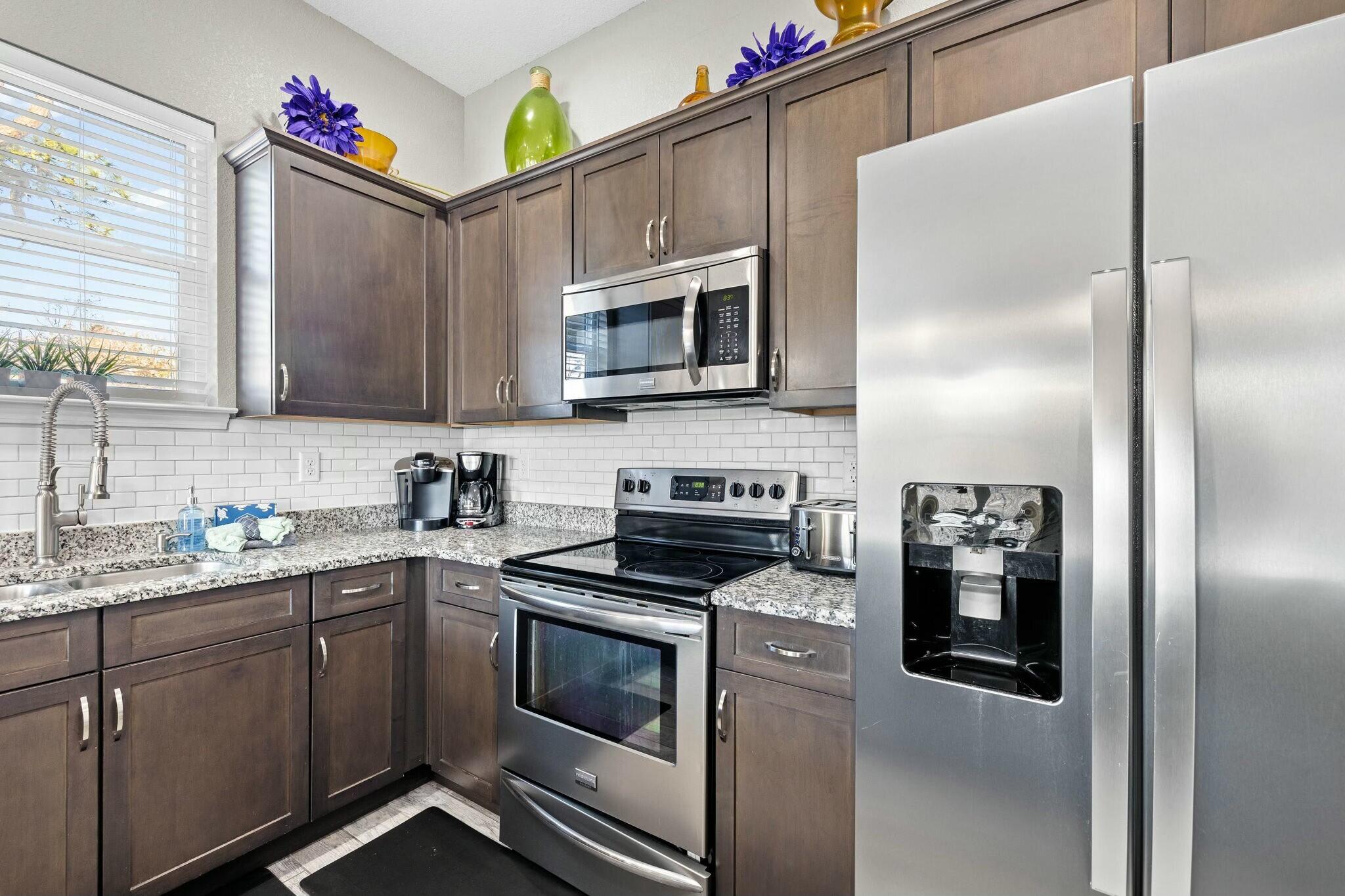 4596 Paradise Isle Destin, FL 32541 - Photo 30 of 60 a kitchen with stainless steel appliances granite countertop a refrigerator and a stove