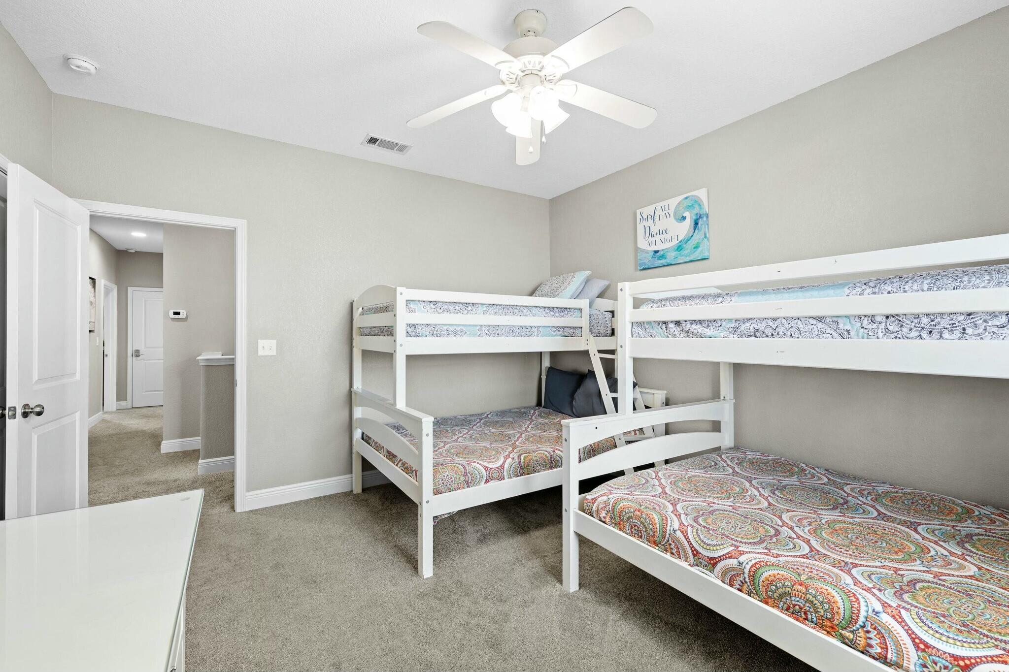 4596 Paradise Isle Destin, FL 32541 - Photo 33 of 60 a bedroom with bed and a chandelier