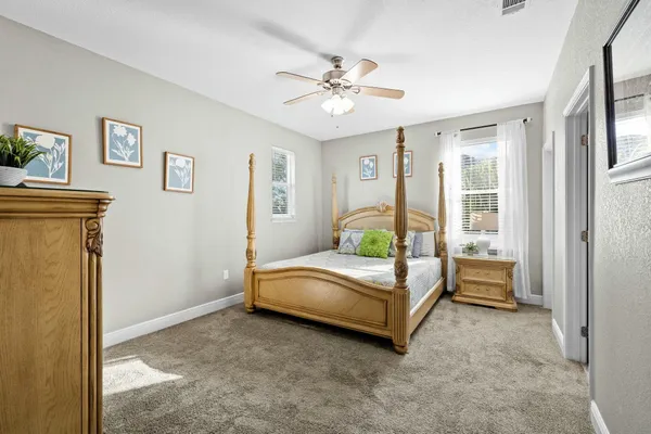 a bedroom with a bed table and window