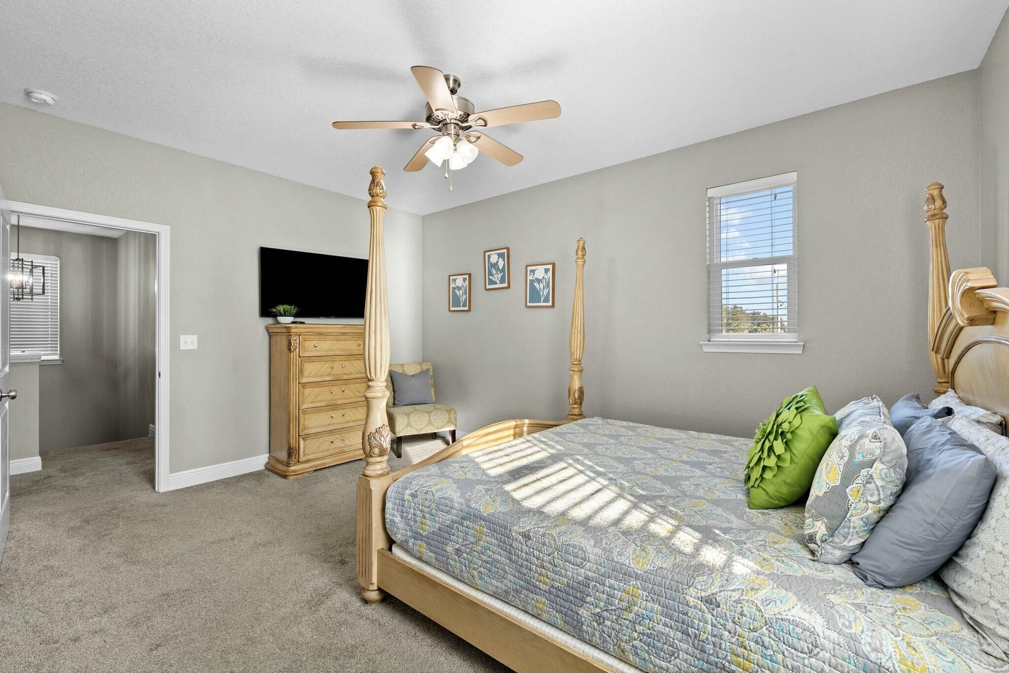 4596 Paradise Isle Destin, FL 32541 - Photo 36 of 60 a bedroom with a bed and a flat screen tv