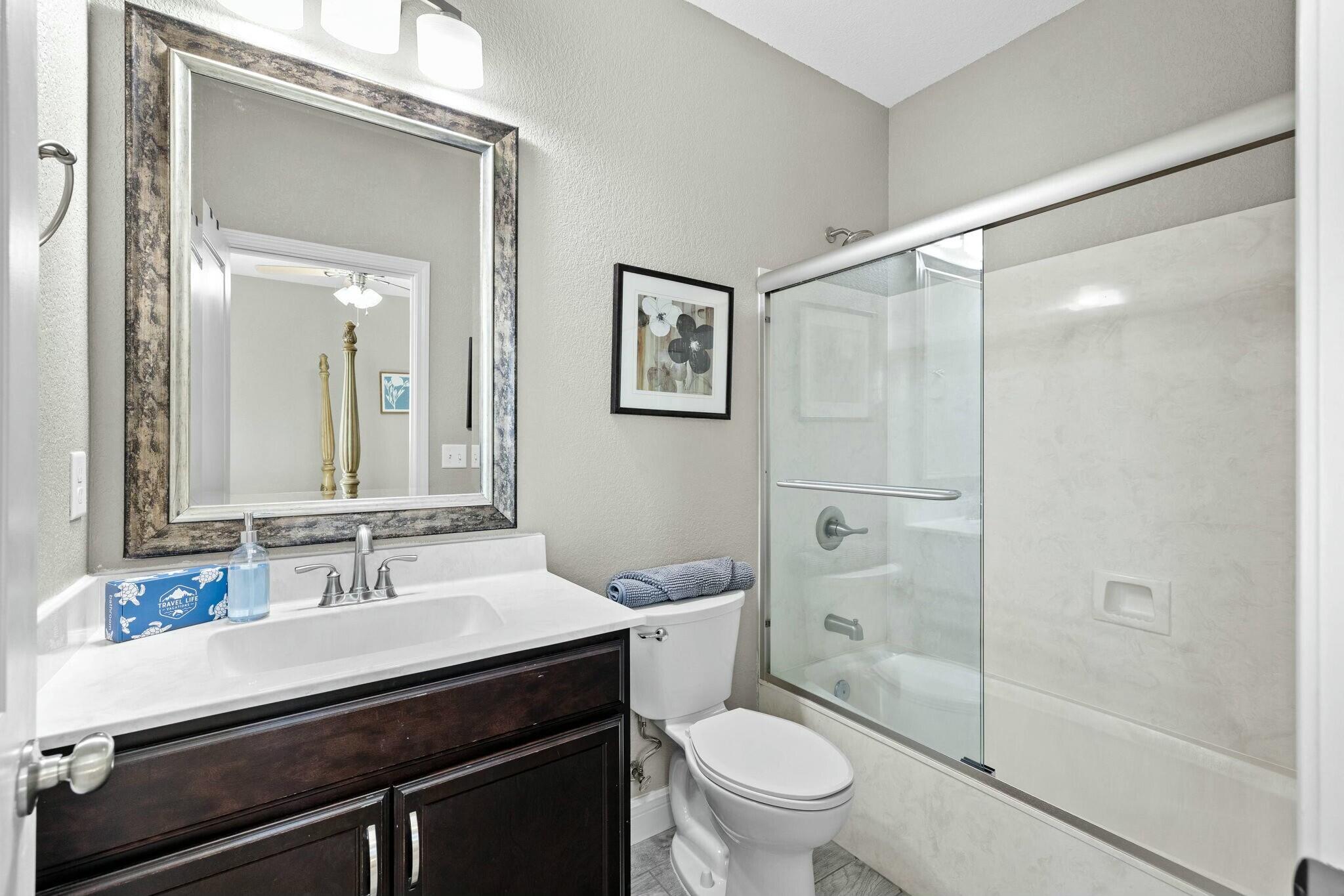 4596 Paradise Isle Destin, FL 32541 - Photo 37 of 60 a bathroom with a sink a toilet a shower and a mirror