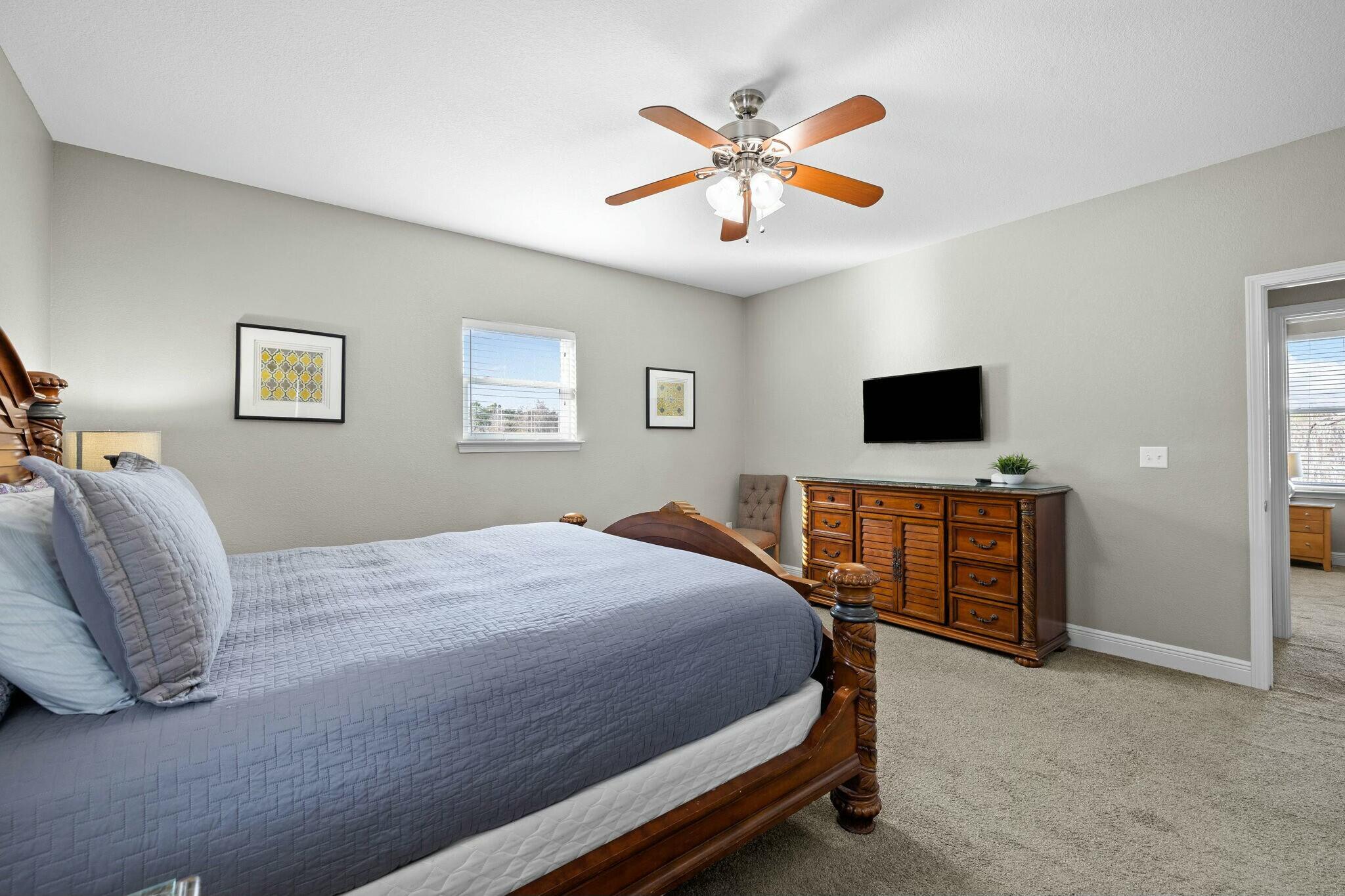 4596 Paradise Isle Destin, FL 32541 - Photo 42 of 60 a bedroom with a bed and a ceiling fan