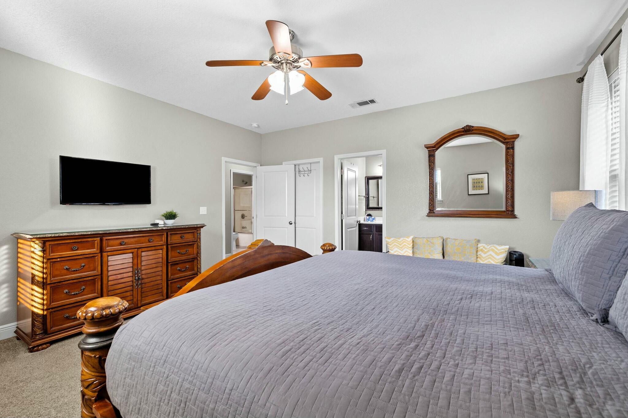 4596 Paradise Isle Destin, FL 32541 - Photo 43 of 60 a bedroom with a large bed and flat tv screen