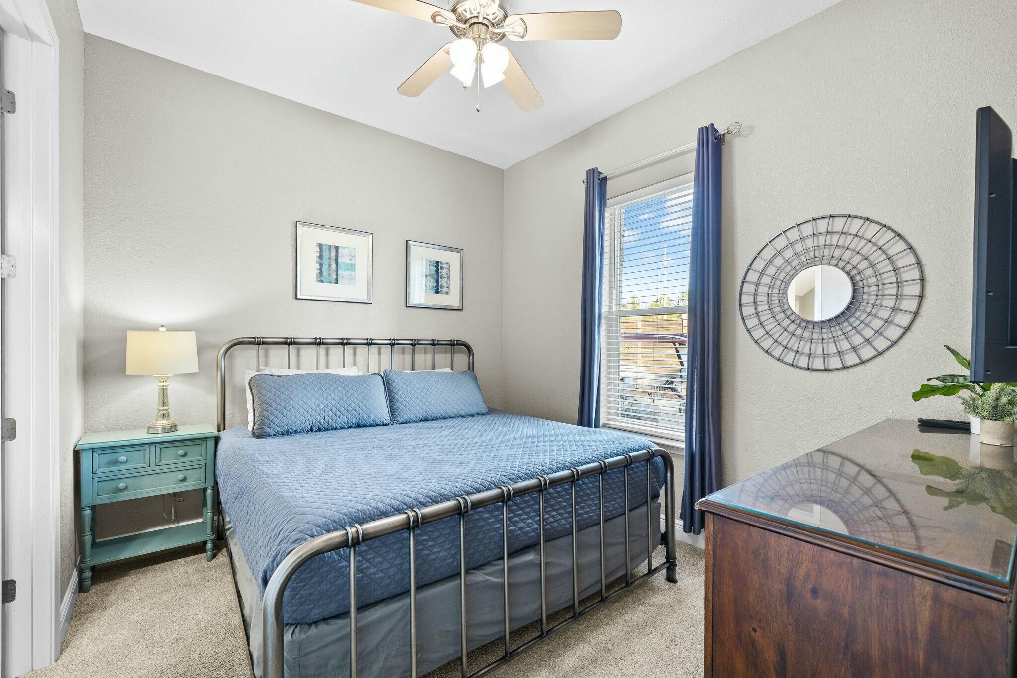 4596 Paradise Isle Destin, FL 32541 - Photo 8 of 60 a bedroom with a large bed and a chandelier