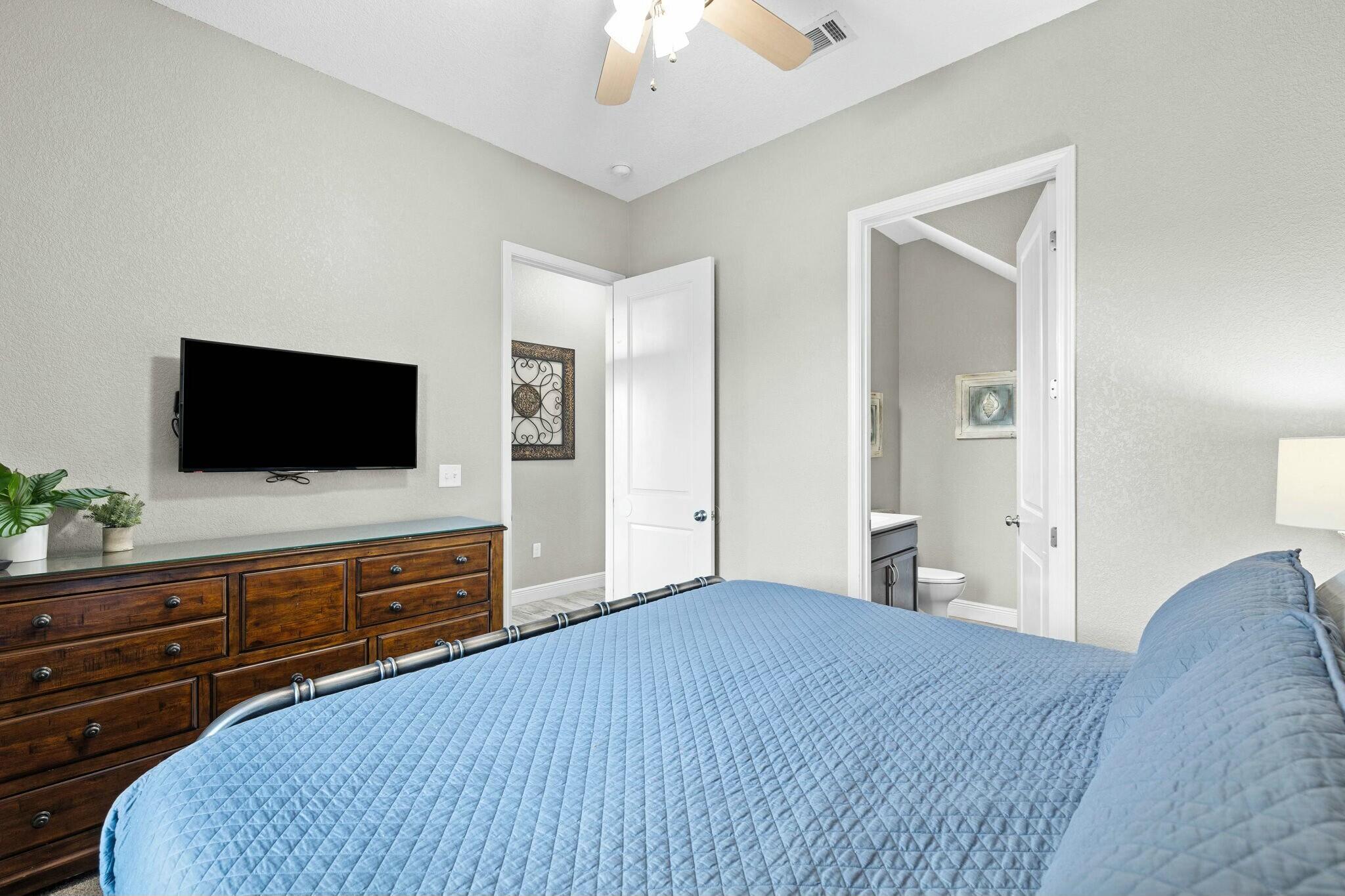 4596 Paradise Isle Destin, FL 32541 - Photo 9 of 60 a bedroom with a bed and a flat screen tv
