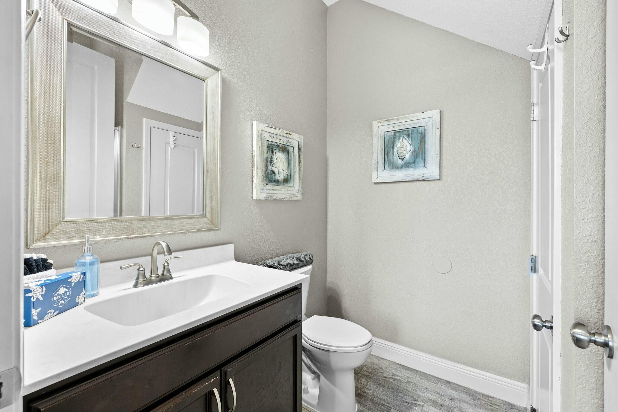 4596 Paradise Isle Destin, FL 32541 - Photo 10 of 60 a bathroom with a sink and a toilet
