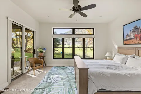 a bedroom with a large bed and a large window