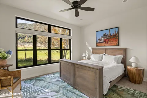 a bedroom with a large bed and a large window
