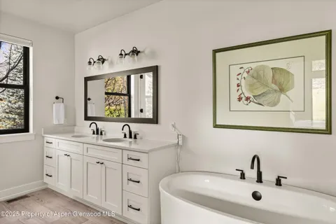 a bathroom with a double vanity sink and a window