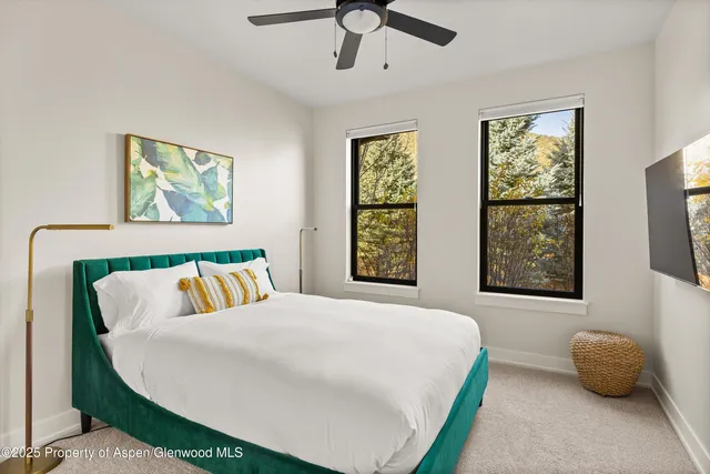 a bedroom with a bed and a painting on the wall