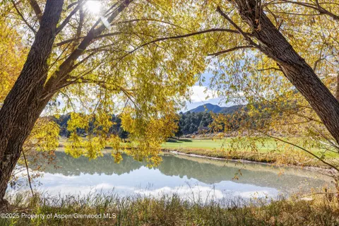 a view of lake from under an umbrella