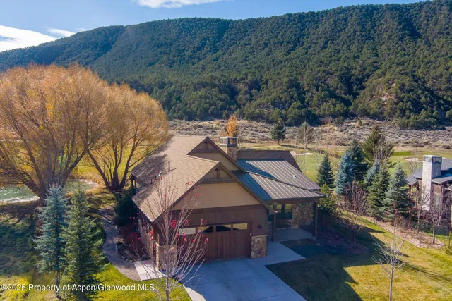 a aerial view of a house with swimming pool table and chairs