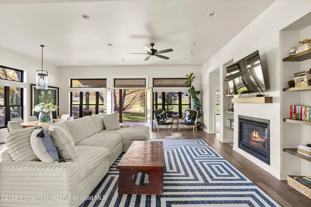 a living room with furniture fireplace and flat screen tv