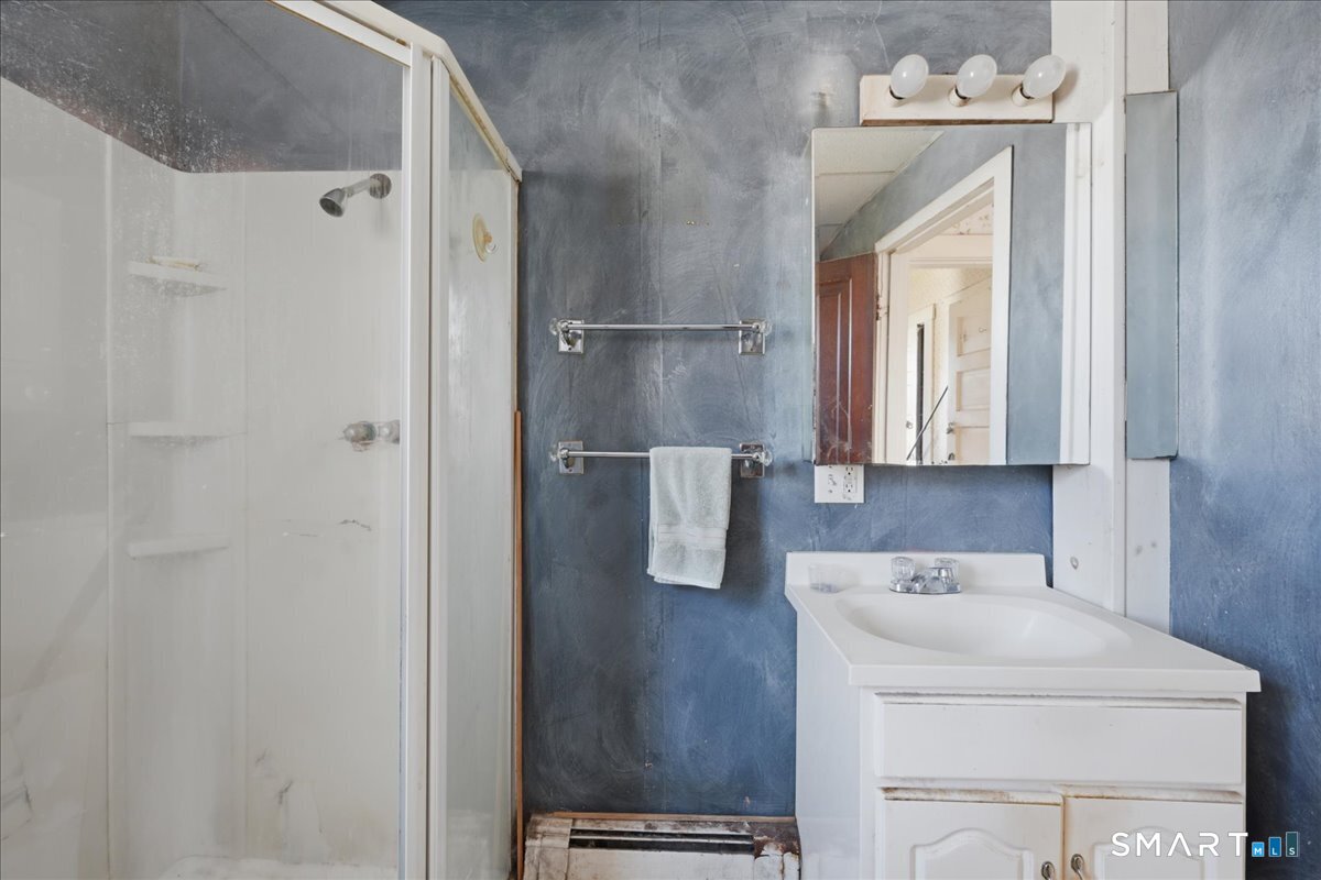 46 Hatch Street Stonington, CT 06355 - Photo 12 of 40 a bathroom with a sink a mirror and shower